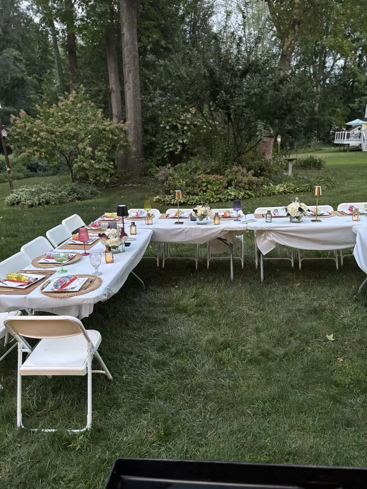 Outdoor dinner party with candlelight and floral centerpieces