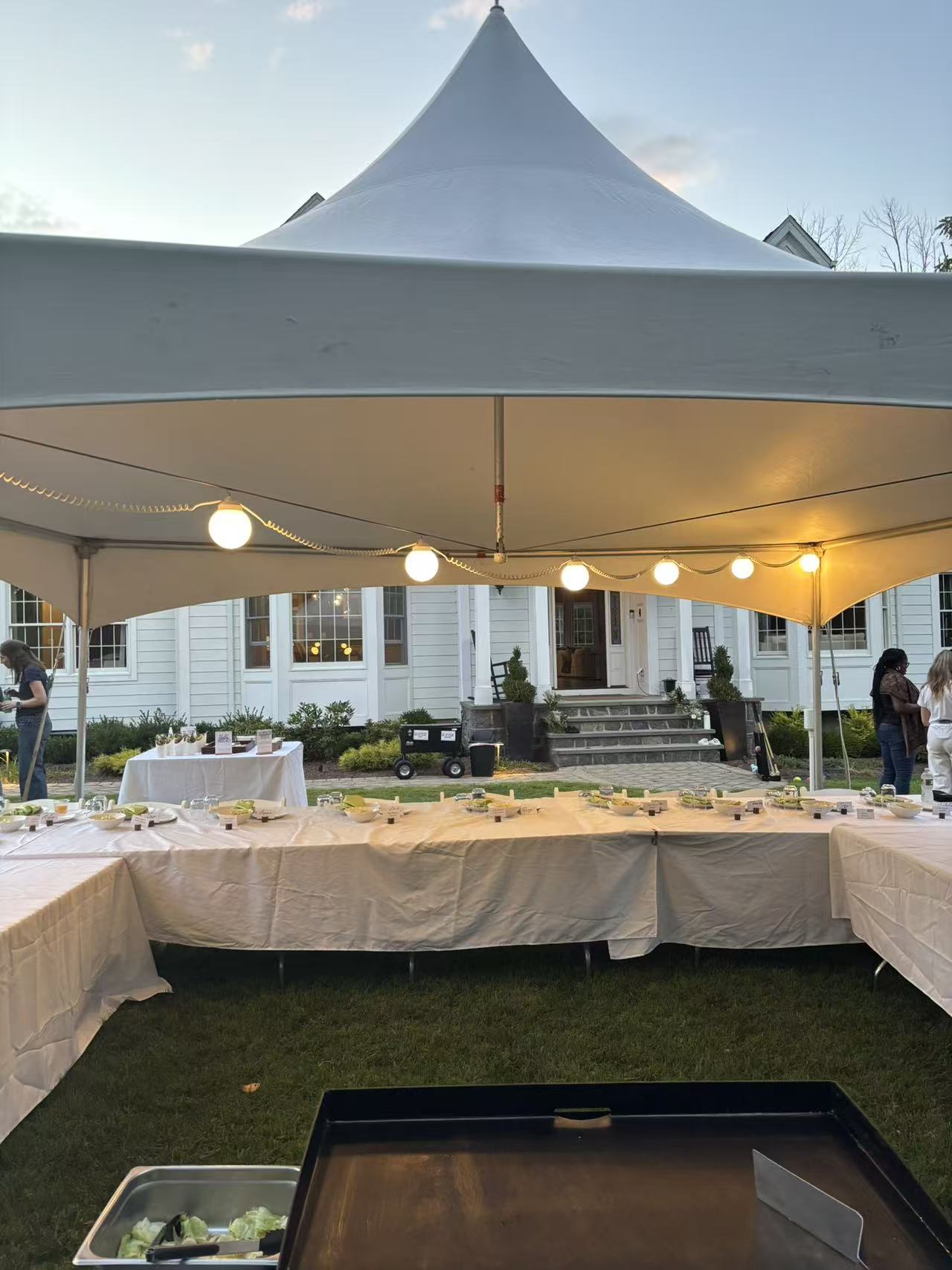Elegant tented hibachi dinner setup at dusk