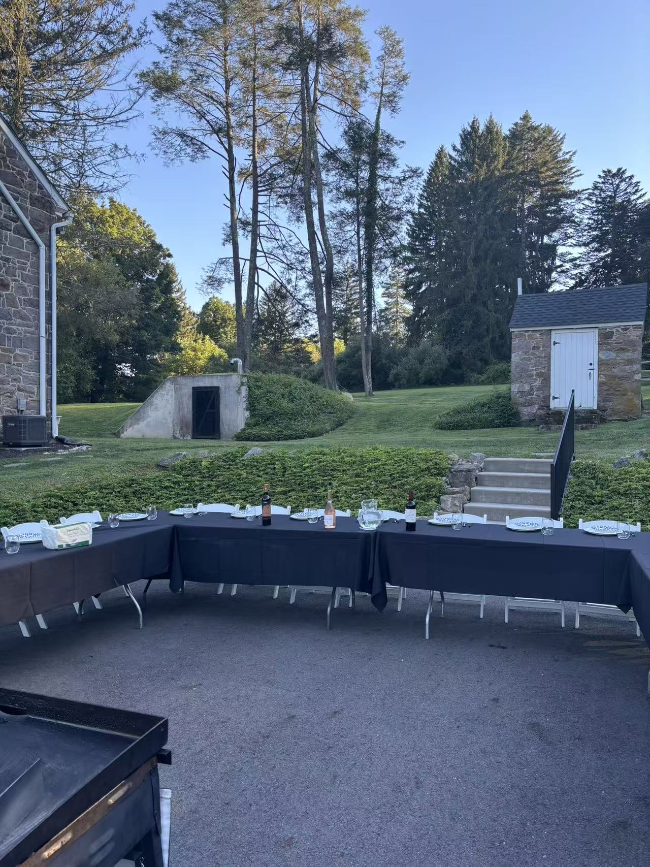 Elegant black tablecloth hibachi setup at a stone estate